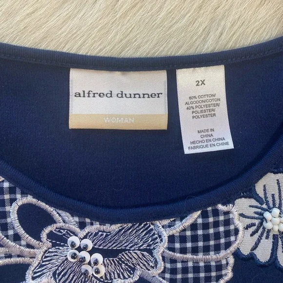 Alfred Dunner navy blue top featuring prominent white floral embroidery - Picture 9 of 10